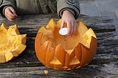 Little girls making a Halloween pumpkin
