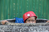 Child or teenager with hat, cap or object on his head.