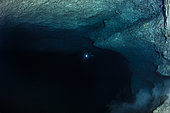 Alone in the dark cave, Mayotte. The diver gives the scale of the cavity.