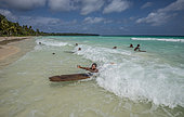 Tara Pacific expedition - november 2017 Yanaba Island, Egum Atoll, Papua New Guinea, Children playing in the waves with self-made surfboards.