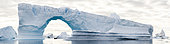 Cruise tourism around an iceberg with natural arch, Antarctica