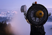 Snow cannon in action and Mont Blanc Massif, at sunset, seen from the station of Brasses, Haute-Savoie, Alps, France