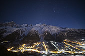 Sea of clouds lit by the Arve valley, by night, and Milky Way, facing the Mole mountain, the Aravis massif, and the Brasses massif, Alps, France