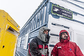 The two managers of postal stewardship (TA64 - TA 65) in front of the postal management of DDU, Dumont-d'Urville Antarctic Base, Terre Adélie, Antarctic