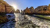 Ponta da Piedade at rising tide, Jagged ocher cliffs, reference landscape of the Algarve, southern province of Portugal