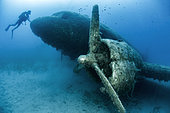 Diver in front of the wreck of a Dakota DC3 plane sunk into a dive site, Kas-Kekova Marine Protected Area, Turkey