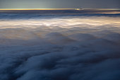Sea of night clouds, lit by Aix les Bains and Chambéry. Stratus on the Savoyard valleys, during a marked temperature inversion. Shooting from Mont Revard. Savoy, France