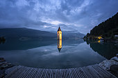 Bell tower of Curon (Graun), at Resia Lake, at dusk, Trentino-Alto Adige, Italy