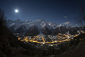 View of Mont-Blanc and the Aiguille du Midi, above the town of Les Houches, in the moonlight. Top right constellation of Orion. Haute-Savoie, France