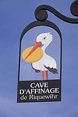 Sign of a ripening cheese maker, stork with a cheese in its beak, rue, Riquewihr, Haut Rhin, France