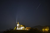 Comet Neowise, meteorite, and Notre-Dame-de-l'Assomption church of Mont-Saxonnex, Haute-Savoie, July 13, 2020 in the late night, France