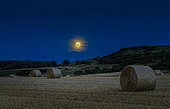 Full moon over a field harvested in summer, Sangatte, Pas de Calais, France