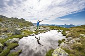 Hiker jumps, reflection in a small lake, Schladminger Höhenweg, Schladminger Tauern, Schladming, Styria, Austria, Europe