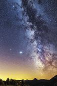 Starry sky in Ardèche, the Milky Way, Jupiter and Saturn shine in a pure sky, north of the Mont Gerbier des Joncs, visible in the middle of the horizon (4 minutes exposure), France