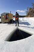 Person who provide contact with the divers inside the maina (sawed entry hole) to dive under the ice, Arctic circle Dive Center, White Sea, Karelia, northern Russia