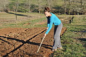 Covering seeds with a rake, Permaculture sowing