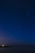 Light of a lighthouse at the beginning of the night in Camargue, France