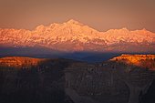 Mont Blanc at sunset, with the Haute Chaine du Jura National Nature Reserve and the Roche Franche in the foreground, Ain, France.