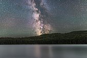 The summer southern Milky Way over Reesor Lake in Cypress Hills Interprovincial Park, a Dark Sky Preserve. Only July 28/29, 2017, just after moonset with Sagittarius in the southwest, and Saturn just about to go behind the treeline. Wind rippled the water and prevented a reflection of stars and the Milky Way. Some airglow tints the sky.