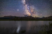 July 13-14, 2020 - The galactic core area of the Milky Way over Maskinonge Pond in Waterton Lakes National Park, Alberta, Canada. Jupiter is the bright object at left, with Saturn dimmer to the left (east) of Jupiter. In the summer of 2020 the two planets were close together in the summer sky. Jupiter provides the glitter path on the water. Antares and Scorpius are to the right. Sagittarius is at centre.
