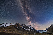 July 27, 2020 - The Milky Way and galactic core area over Mount Andromeda (centre), Mount Athabasca (left) and the Athabasca Glacier (right) at the Columbia Icefields, on a very clear night. . Photographed as the waxing quarter moon was still up but behind Snow Dome at far right, and about to set. Warm low-angle moonlight illuminates the peaks at left with bronze hour lunar alpen glow, and brightens the sky at right, plus adds the blue tint to the sky. But in the clear mountain air, the Milky Way and its starclouds still show up very well. The constellations of Aquila and Scutum are at centre.
