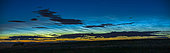 A 45 degree panorama of noctilucent clouds seen the night of June 1-2, 2020 in Alberta, Canada, first at dusk and then later at dawn at about 3:15 a.m. MDT. Dark nearby weather clouds are silhouetted in front of the noctilucent clouds, which are at a height of some 80 km above the Earth near the edge of space. Note the north-south wavy structure and east-west herringbone patterns. Capella is at right of centre. 
