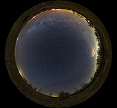 A 360 degree by 180 degree panorama of the northern spring sky taken from Alberta, Canada, on a very clear night April 20, 2020. This is the sky with as little Milky Way as is possible from this latitude. North is at top, south at bottom; west is to the right, east to the left. . The North Pole of the Milky Way is just below centre here, near the large Coma Berenices star cluster. I shot this as a demonstration of the view looking up out of the plane of the Milky Way toward its galactic pole and the realm of the galaxies in the spring sky. . . As a result of the orientation of the Earth at this time of year, the Milky Way is as low as it gets from the latitude of 51 degrees North and appears here as a low arc across the northern horizon at top. . . To the south at bottom the faint glow of Gegenschein is visible in Virgo around the star Spica. There is the suggestion of the even fainter Zodiacal Band stretching across the south over to the western sky at right brightened by light pollution and with a few annoying clouds over the urban areas to the west. . . Gemini, Cancer and Leo are at right; Auriga and Perseus are at top right. Arcturus is the bright star left of centre, Vega is the bright star at top left, rising. The Big Dipper and Ursa Major are overhead at the zenith. Polaris is above centre due north. 

