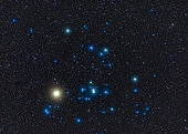 The Hyades star cluster with the red giant star Aldebaran (looking yellow here) in Taurus the bull in the winter sky.