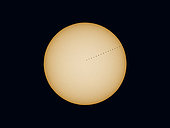 A composite of the November 11, 2019 transit of Mercury across the disk of the Sun, on a day with no sunspots on the Sun. . . North is up here, with Mercury moving from left to right, east to west, across the Sun above the ecliptic which itself is angled up in relation to the cardinal directions. 
