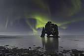 Northern lights over Hvitserkur, a spectacular rock formation in Iceland.