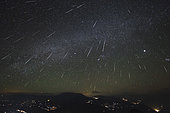 The Geminids meteor shower streaks across the clear sky above Yunnan province of China. This image is a composite result of wide-angle photo sequence taken from 3 hours before dwan on December 14, 2012.