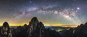 The arc of the Milky Way and a bright streaking meteor are captured in this panorama view from Mount Huangshan, Anhui province of China. Known as the loveliest mountain of China, Huangshan is a frequent subject of traditional Chinese paintings and literature, as well as modern photography. It is a UNESCO World Heritage Site, and one of China's major tourist destinations.
