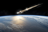 A meteor streaks towards a collision with Earth as it breaks up over the ocean. Clouds cover an ocean area of the planet.