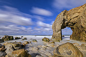 Granite arch of Port Blanc, emblem of the Côte Sauvage de Quiberon, Hercynian granite eroded by the sea, Brittany, France