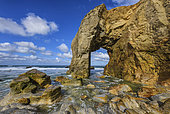 Granite arch of Port Blanc, emblem of the Côte Sauvage de Quiberon, Hercynian granite eroded by the sea, Brittany, France