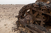 A rusted derelict Caterpillar used in diamond mining, buried in sand. Skeleton Coast, Kunene, Namibia.