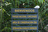 A sign at the entrance to Corcovado National Park. Corcovado National Park, Osa Peninsula, Costa Rica.