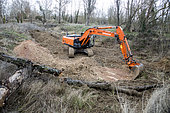 Digging a pond to promote amphibian reproduction in the Luberon Regional Nature Park, Vaucluse, France.