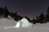 Igloo lit up in night view in Vercors, France