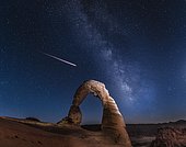Natural Arch Delicate Arch with Milky Way and shooting star at night, Arches National Park, Moab, Utah, USA, North America