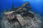 Sunken excavator. Despite not being heavily colonized by marine species, it can be considered a wreck, or an artificial ecosystem of scenic interest for divers. Underwater bottoms of Tenerife, Canary Islands.