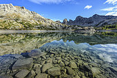 The lake of Allos and its sandstone towers of Annot, in the Haut Verdon, Alpes de Haute-Provence. A very pure lake, populated by Arctic char and trout, and located at 2230 meters of altitude in the Mercantour national park, in the Alpes-de-Haute-Provence. Dominated by Mount Pelat (3052 metres) to the north and by the sandstone towers of Annot to the south, it is the largest natural high altitude lake in Europe