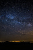 Starry night and light pollution on the mountain ridge of Lure, Provence, France