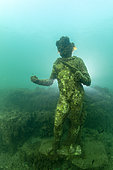 Statue of Dionysus with ivy crown, god of intoxication and happiness. Located in the submerged Nymphaeum of Emperor Claudius, near Punta Epitaffio , Marine Protected Area of Baia, Naples, Italy, Tyrrhenian Sea
