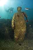 Scuba diver with Statue of Antonia minor, member of the Julio-Claudian dynasty daughter of Marcus Anthony and the sister of the emperor Augustus, Octavia minor. Located in the submerged Nymphaeum of Emperor Claudius, near Punta Epitaffio , Marine Protected Area of Baia, Naples, Italy, Tyrrhenian Sea