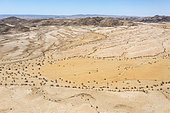 Badlands and dry river beds after years of drought. Aerial view. Drone shot. Kaokoland, Kunene Region, Namibia.