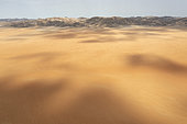Sandy desert plain and bare mountain ranges. Aerial view. Drone shot. Kaokoland, Kunene Region, Namibia.