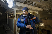 Nikita Tananaev, researcher, explaining the melting permafrost in one of the underground laboratories of the permafrost institute for studying permarfrost and storing cores at negative temperatures, Yakutsk, Republic of Sakha, Russia