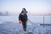 Extraction of ice cube from the Lena river for use as drinking water by residents without access to running water, Yakutsk, Republic of Sakha, Russia