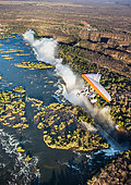 Tourists fly over the Victoria Falls on the trikes. Africa. Zamb
